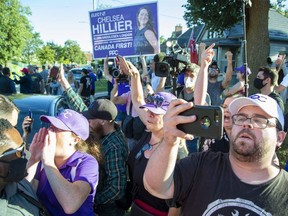 People protest outside of Liberal Leader Justin Trudeau's campaign bus after a stop at the London Brewing Co-operative in London on Monday. (Derek Ruttan/The London Free Press)
