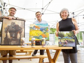 The work of artists L to R Jamie Jardine, Peter Karas and Marilyn Lazenby decorates cans of beer at London Brewing Co-op in London. (Derek Ruttan/The London Free Press)