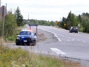 An OPP cruiser can be seen near a road block set up at Kukagami Lake Road and Highway 17 east of Sudbury, Ontario on Thursday, September 2, 2021. Police took a 28-year-old man into custody without incident after he allegedly drove a pickup truck aggressively and erratically through parts of Greater Sudbury and onto the highway, becoming involved in multiple collisions, before heading to the Kukagami/Ashagami area. Roads were blocked and residents of the area were asked to shelter in place prior to the man's arrest. Ben Leeson/The Sudbury Star/Postmedia Network