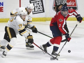 Ryder McIntyre, left, and Zach Filak of the Sarnia Sting tie up Spencer Lecot of the Windsor Spitfires during their pre-season game on Sunday, September 19, 2021, at the WFCU Centre in Windsor, Ont. (Dan Janisse/The Windsor Star) council