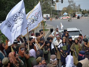 Taliban fighters holding Taliban flags gather along a street during a rally in Kabul on Aug. 31, 2021 as they celebrate after the U.S. pulled all its troops out of the country to end a brutal 20-year war -- one that started and ended with the hardline Islamist in power.