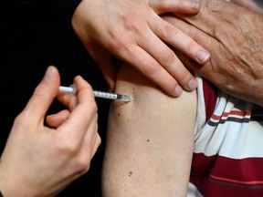 A man receives a dose of the Pfizer/BioNTech Covid-19 vaccine at the Robert Poirier athletics stadium turned into a vaccination centre in Rennes, Britany, on April 7, 2021. (Photo by Damien MEYER / AFP) (Photo by DAMIEN MEYER/AFP via Getty Images)
FOR PAGINATORS:
Vaccinations against COVID-19 continue locally, though at a slower pace than during the summer.