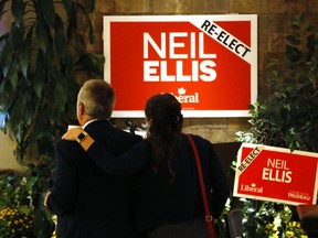 Abigail Ellis rests a supportive hand on the shoulder of her father, Bay of Quinte Liberal incumbent Neil Ellis, early Tuesday morning after his loss to Conservative Ryan Williams.