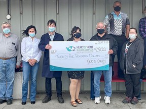 Hospice Quinte Executive Director, Jennifer May-Anderson (centre) joins ReidÕs Dairy President, Stephen Quickert (fifth from the left) and staff for a $25K cheque presentation to support Hospice Quinte's Heart & Home Building Campaign. SUBMITTED PHOTO