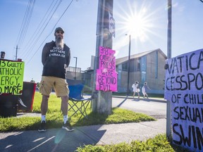William OÕSullivan, a childhood abuse survivor, stands alongside protest signs in front of Queen Of The Most Holy Rosary Sunday in Belleville, Ontario. O'Sullivan is campaigning towards Ottawa demanding an independent inquiry into the catholic church on abuse allegations. ALEX FILIPE