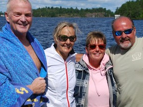 Joe and Averil Wiley (left) and Bonny and Dave Ranger celebrate the end of the 11.9-kilometre swim on Lake Wanapitei that was part of a fundraiser to help establish a fellowship to research mental health and addiction.