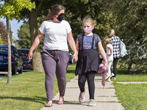 Jessica Hill walks with her nine-year-old daughter, Alexis Lowes, at the end of the school day on Tuesday in Brantford, Ontario. Alexis started Grade 4 at Branlyn School.