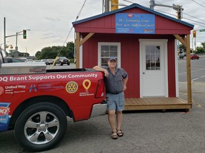 Dairy Queen owner Ken Breau has been told by city officials to either move Red Shed that he placed on his parking lot  to help charities or apply for a minor variance to keep it in its current location at a cost of $2,585.