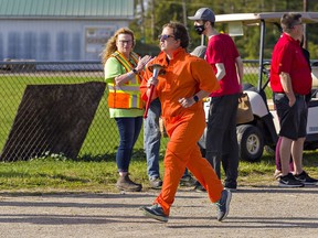 Kiara Wilson of Cambridge carries the torch as she runs the track at the Paris Fairgrounds on Saturday September 18, 2021 during the Law Enforcement Torch Run in support of Special Olympics.