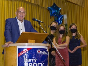 An elated Larry Brock speaks to Conservative supporters Monday at the Polish Hall in Brantford after winning the Brantford-Brant riding in the 2021federal election. Joining him on stage are his wife Angela and 12-year-old daughters Jennie and Emma (right).