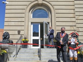 Brantford Mayor Kevin Davis cuts a ribbon to official open the new city hall on Saturday.