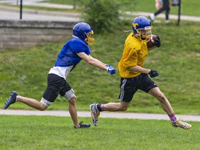 Ball carrier Liam Young remains just beyond the reach of defender Ethan Bush as the BCI Mustangs senior boys football team holds a practice this week.