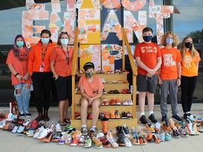 Grade 8 student Alona Pratt (left), teachers Hilary Wiebbe and Sarah Gasparotto, and other Grade 8 students Caleb Clugston, Everett Janes, Parker Salama and Peyton Baetz participated in a collaborative art display that involved all the students at Ecole Confederation to mark Orange Shirt Day and the first National Day for Truth and Reconciliation.