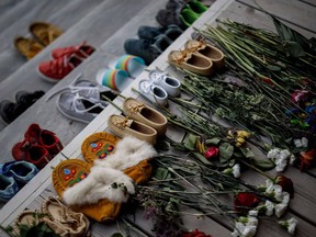 Flowers, shoes and moccasins sit on the steps of the main entrance of the former Mohawk Institute in Brantford as a tribute to children who died at residential schools.