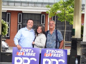 Alex Cassell, left, fellow PPC candidate Shelley Sayle-Udall and Independent MPP Randy Hillier pose for a picture by a drone after a rally in Gananoque earlier this month. (FILE PHOTO)
