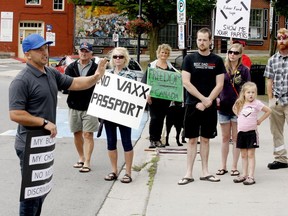 Mike Kench, left, speaks to participants at a rally opposing Ontario's planned vaccine passport system, in front of Gananoque town hall on Sunday morning. (RONALD ZAJAC/The Recorder and Times)