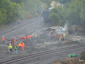 Late Wednesday morning, Prescott firefighters spray the area where two derailed locomotives had rested since Thursday morning's collision west of the Edward Street overpass. Tim Ruhnke/The Recorder and Times
