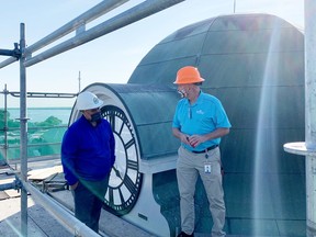 Brockville Mayor Jason Baker, left, and city facilities supervisor Les Johnston converse by the main clock face on the Victoria Building clock tower on Tuesday morning. (RONALD ZAJAC/The Recorder and Times)