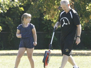 Avah-Marie Gagnon looks on as Brockville Boomerang Club president Brian Curley prepares to measure her throw during a tournament on Saturday. Fourteen youngsters took part in the event held at the park on Dana Street.
Tim Ruhnke/The Recorder and Times