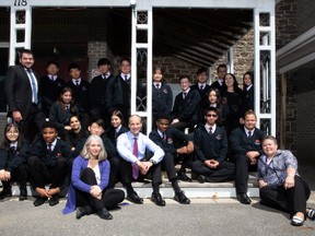 Headmaster Kevin Farrell, centre, students and fellow staff pose for a photo at Merrick Preparatory School. (JESSICA MUNRO/Local Journalism Initiative Reporter)