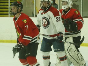 Ottawa captain Thomas Freel stands between Brockville defenceman Kevin Fitzgerald and goalie Brandon Abbott during a Jr. Senators power play in the Braves' CCHL home-opener Friday.
Tim Ruhnke/The Recorder and Times