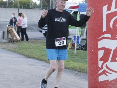 Octogenarian John Sheehan from Cardinal crosses the finish line at the Twilight Fun Run in Johnstown.
Tim Ruhnke/The Recorder and Times