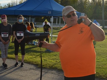 Race director Michel Larose provides instructions to participants before they hit the course at the inaugural Twilight Fun Run at the Port of Johnstown on Saturday.
Tim Ruhnke/The Recorder and Times