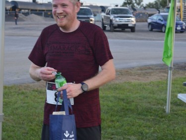 Steve Gabell, who was first among the earliest group of runners to finish the 5-km fun run course, picks up his swag bag and medal.
Tim Ruhnke/The Recorder and Times
