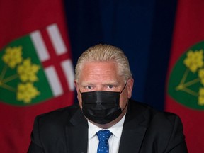 Ontario Premier Doug Ford listens to a question Wednesday, Sept. 1, during a media conference at Queen's Park announcing the enhanced COVID-19 vaccine certificate system.