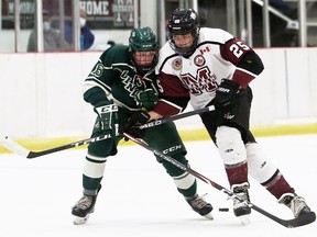 Chatham Maroons' Cameron Graham, right, and St. Marys Lincolns' Myles Baker battle for the puck in the first period at Chatham Memorial Arena in Chatham, Ont., on Sunday, Sept. 26, 2021. Mark Malone/Chatham Daily News/Postmedia Network