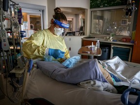 A registered nurse works with a COVID-19 patient on the Intensive Care Unit at Foothills Medical Centre on Sept. 10, 2021. PHOTO BY AHS