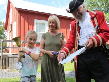 Town Crier Wes Libbey at the Harvest Festival at the Glengarry Pioneer Museum, getting some assistance from Charlotte Laub and her grandmother Wendy Shields. Photo on Sunday, September 12, in Dunvegan, Ont. Todd Hambleton/Cornwall Standard-Freeholder/Postmedia Network