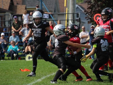 Cornwall Wildcats Mosquito Division team quarterback Bryce Camplin (11) collides with a South Gloucester Raiders player during a running play. Photo on Sunday, September 12, 2021, in Cornwall, Ont. Todd Hambleton/Cornwall Standard-Freeholder/Postmedia Network