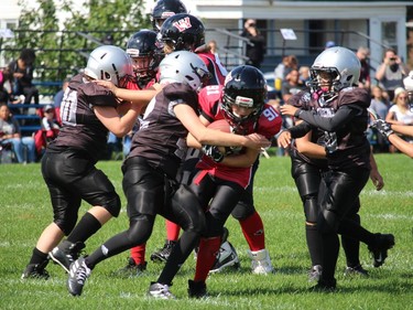 The South Gloucester Rangers needed several players to tackle Wildcats' ball carrier Charles Emile Nadeau on this play at Joe St. Denis Field. Photo on Sunday, September 12, 2021, in Cornwall, Ont. Todd Hambleton/Cornwall Standard-Freeholder/Postmedia Network