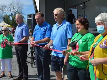 From left, Elaine Sipes, MPP Jim McDonell, MP Eric Duncan, South Dundas Mayor Steven Byvels, Anita Milne and Evonne Delegarde cut the ribbon at the third annual Iroquois Apple Festival Saturday September 18, 2021 in Iroquois, Ont. Shawna O'Neill/Cornwall Standard-Freeholder/Postmedia Network