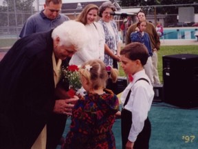Terry Fox's mother Betty Fox (pictured left, holding flowers) was gifted flowers by local children when she visited Cornwall in 1997. Chris Nicholls, 2021 co-organizer, is the boy pictured in front wearing the white shirt. His involvement in the event spans over 24 years. Handout/Cornwall Standard-Freeholder/Postmedia Network