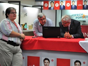 Liberal campaign volunteers Christine Paquette and Denis Sabourin observe results during election night, with SDSG Liberal candidate Denis Moquin (right). Photo taken on Monday September 20, 2021 in Cornwall, Ont. Francis Racine/Cornwall Standard-Freeholder/Postmedia Network