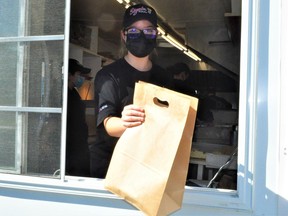 Bianca Beaudry was one of the handful of Seguin Patate staff members that volunteered during the business's last day of the season. Proceeds from all of the day's sales were donated to the Agape Centre. Photo taken on Saturday September 25, 2021 in Cornwall, Ont. Francis Racine/Cornwall Standard-Freeholder/Postmedia Network