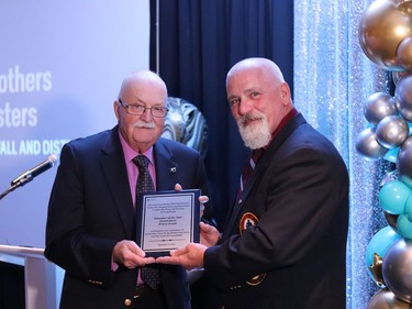 Big Brothers Big Sisters of Cornwall and District executive director Ron Graham (right) with a plaque presentation to volunteer of the year D'Arcy Grant.Handout/Cornwall Standard-Freeholder/Postmedia Network
