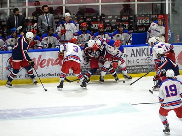 Cornwall Colts and Rockland Nationals players scrum for the puck against the boards in front of Rockland's bench during exhibition play on Thursday September 16, 2021 in Cornwall, Ont. Cornwall won 2-1. Robert Lefebvre/Special to the Cornwall Standard-Freeholder/Postmedia Network