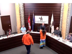 Sweetgrass and tobacco are presented to town council by Stoney Nakoda cultural ambassador Gloria Snow and her husband during the September 13 meeting, which included discussion on truth and reconciliation. Town of Cochrane YouTube