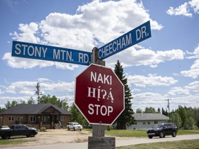 A stop sign in Anzac, Alta. in Cree (top), Dene and English on Sunday, June 13, 2021. Robert Murray/Special to Postmedia/Fort McMurray Today