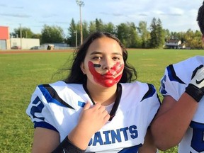 Alicia Gladue of the FMCSD's Saints football team in Fort McMurray. At a practice, she has a red handprint over her face to acknowledge MMIWG2S victims. Supplied image