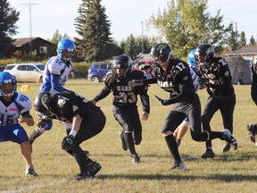 Hanna Hawks #34 Wendal Siewert, #33, Lane Andrus, #17 Dylan Hann, #27 Easton Scheerschmidt and #50 Ryan Reading form a bockage during the Sept. 24 home game against the Camrose Royals. The Hawks took home the win with ease against the Royals, wwho had a short bench, with a final score of 82-7. Jackie Irwin/Postmedia