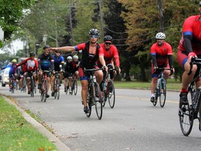 Ride to Remember participants pass by City Park in Kingston on Friday.