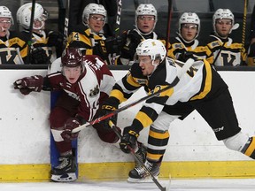 Kingston Frontenacs' Jake Murray knocks Peterborough Petes' Carson Whitson into the boards in an Ontario Hockey League pre-season game at the Leon's Centre on Saturday, Sept. 25, 2021. The Frontenacs won the game, 6-3.