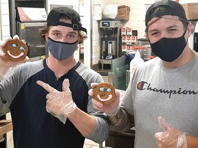 Kirkland Lake Gold Miners Eric de Repentigny and Curtis Gervais helped to decorate Smile Cookies during the recent Tim Hortons campaign.