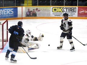 Kirkland Lake Gold Miners' goalie Zach Reddy makes the save and defence Spencer Jones gets ready to handle the rebound during the Miners 3-1 over Cochrane.