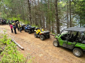 Members of the Renfrew County ATV Club out for a group ride along a local trail.