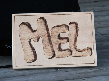 A small woodburned sign on the stage.